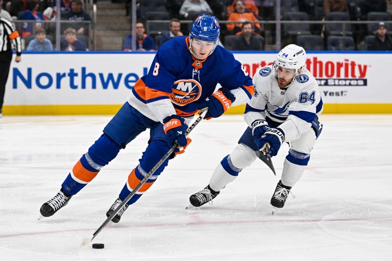 Feb 8, 2024; Elmont, New York, USA; New York Islanders defenseman Noah Dobson (8) skates with the puck chased by Tampa Bay Lightning center Tyler Motte (64) during the first period at UBS Arena. Mandatory Credit: Dennis Schneidler-USA TODAY Sports