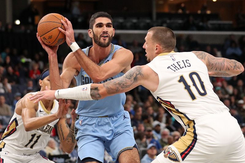 MEMPHIS, TENNESSEE - NOVEMBER 29: Santi Aldama #7 of the Memphis Grizzlies drives to the basket against Daniel Theis #10 of the New Orleans Pelicans during the first half of an Emirates NBA Cup game at FedExForum on November 29, 2024 in Memphis, Tennessee. NOTE TO USER: User expressly acknowledges and agrees that, by downloading and or using this photograph, User is consenting to the terms and conditions of the Getty Images License Agreement. (Photo by Justin Ford/Getty Images)