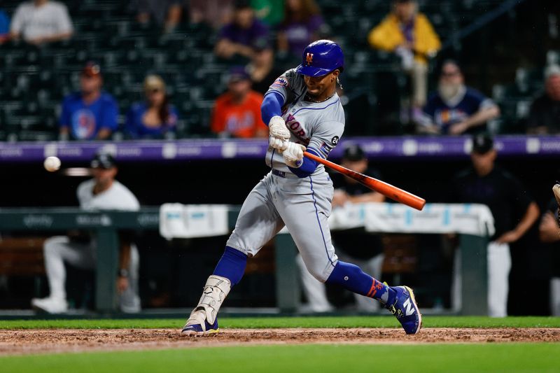 Aug 6, 2024; Denver, Colorado, USA; New York Mets shortstop Francisco Lindor (12) hits a single in the seventh inning against the Colorado Rockies at Coors Field. Mandatory Credit: Isaiah J. Downing-USA TODAY Sports