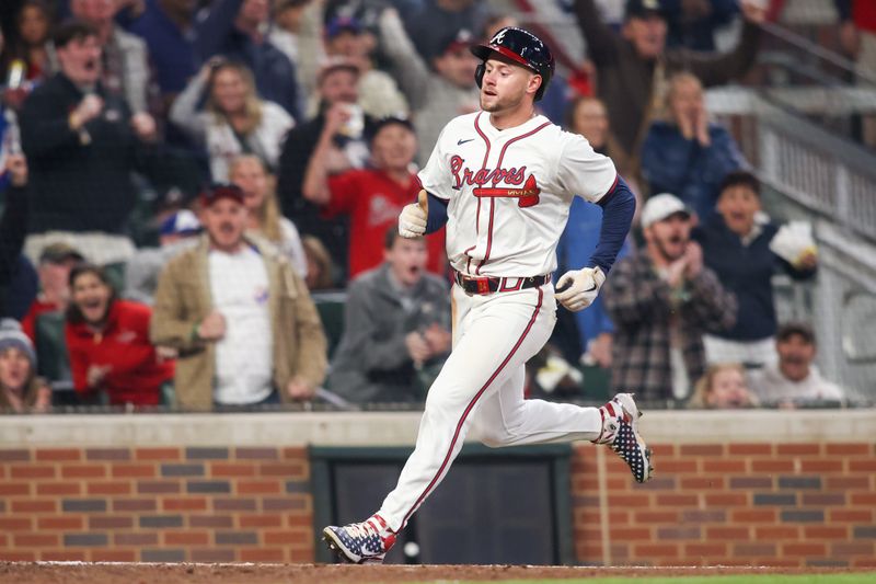 Apr 6, 2024; Atlanta, Georgia, USA; Atlanta Braves left fielder Jarred Kelenic (24) scores a run against the Arizona Diamondbacks in the eighth inning at Truist Park. Mandatory Credit: Brett Davis-USA TODAY Sports