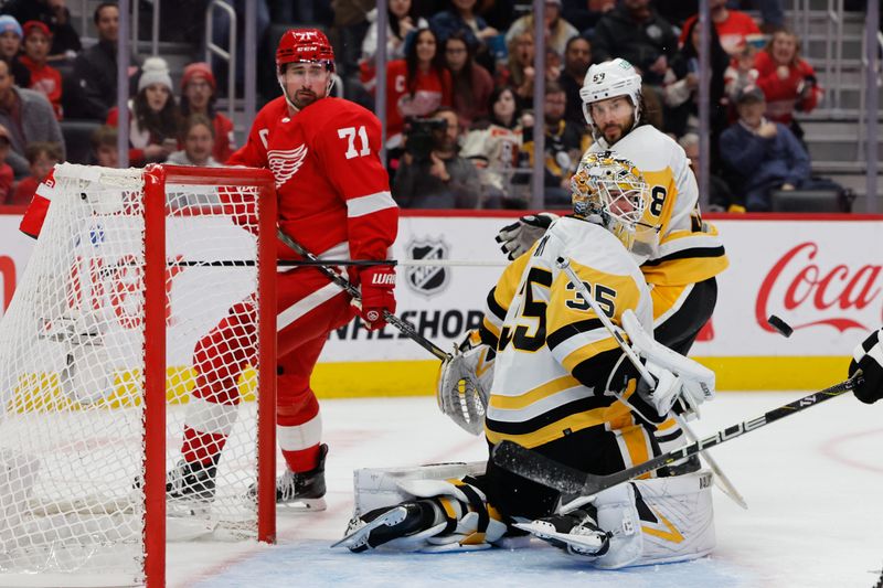 Oct 18, 2023; Detroit, Michigan, USA; Pittsburgh Penguins goaltender Tristan Jarry (35) makes a save on Detroit Red Wings center Dylan Larkin (71) in the second period at Little Caesars Arena. Mandatory Credit: Rick Osentoski-USA TODAY Sports