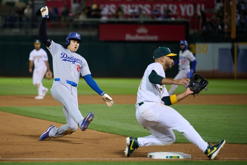 Aug 3, 2024; Oakland, California, USA; Los Angeles Dodgers designated hitter Shohei Ohtani (17) steals third base against Oakland Athletics infielder Abraham Toro (31) during the ninth inning at Oakland-Alameda County Coliseum. Mandatory Credit: Robert Edwards-USA TODAY Sports