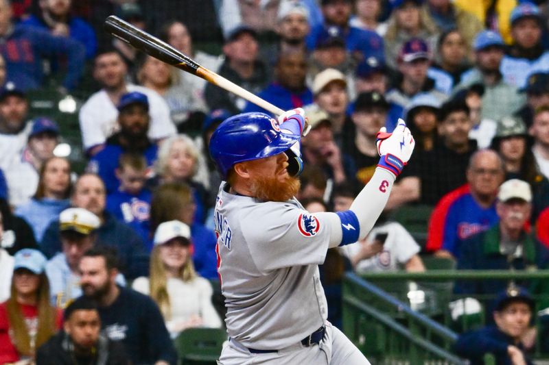 May 3, 2025; Milwaukee, Wisconsin, USA; Chicago Cubs first baseman Justin Turner (3) drives in a run with a base hit in the first inning against the Milwaukee Brewers at American Family Field. Mandatory Credit: Benny Sieu-Imagn Images