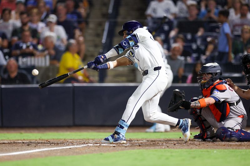 May 19, 2025; Tampa, Florida, USA; Tampa Bay Rays right fielder Jose Caballero (77) hits an rbi double against the Houston Astros in the sixth inning  at George M. Steinbrenner Field. Mandatory Credit: Nathan Ray Seebeck-Imagn Images