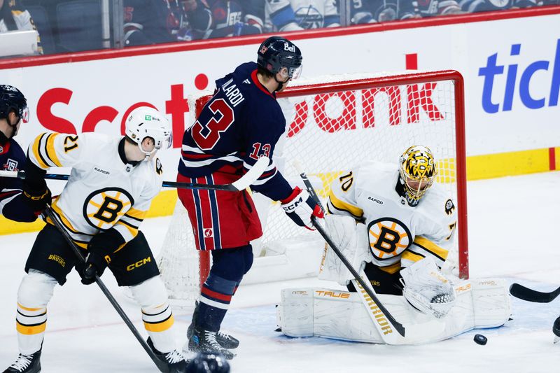 Dec 11, 2025; Winnipeg, Manitoba, CAN; Boston Bruins goalie Joonas Jorpisalo (70) makes a save as Winnipeg Jets forward Gabriel Vilardi (13) looks for a rebound during the first period at Canada Life Centre.  Mandatory Credit: Terrence Lee-Imagn Images