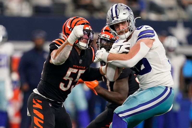 Dallas Cowboys tight end Dalton Schultz (86) makes a catch as Cincinnati Bengals linebacker Logan Wilson (55) makes the tackle during the second half of an NFL football game Sunday, Sept. 18, 2022, in Arlington, Tx.The ball came loose during the play and Cincinnati recovered the fumble. (AP Photo/Tony Gutierrez)