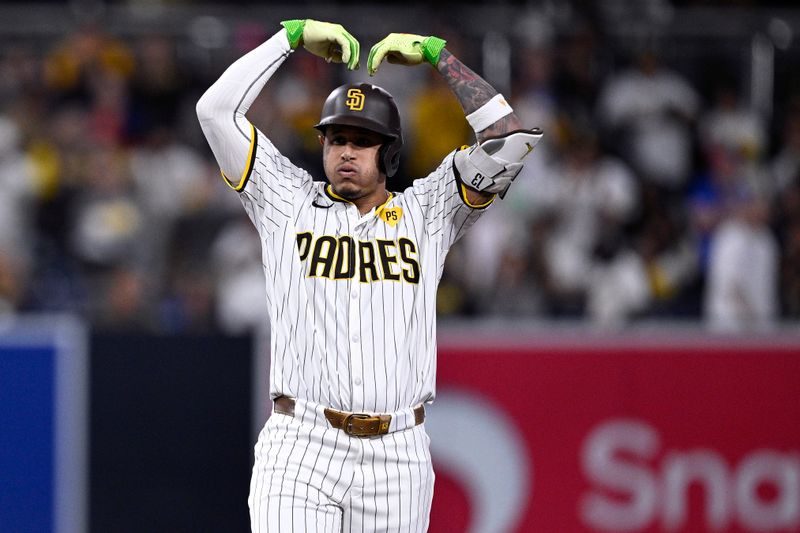 Sep 16, 2024; San Diego, California, USA; San Diego Padres third baseman Manny Machado (13) celebrates after hitting an RBI double against the Houston Astros during the first inning at Petco Park. Mandatory Credit: Orlando Ramirez-Imagn Images