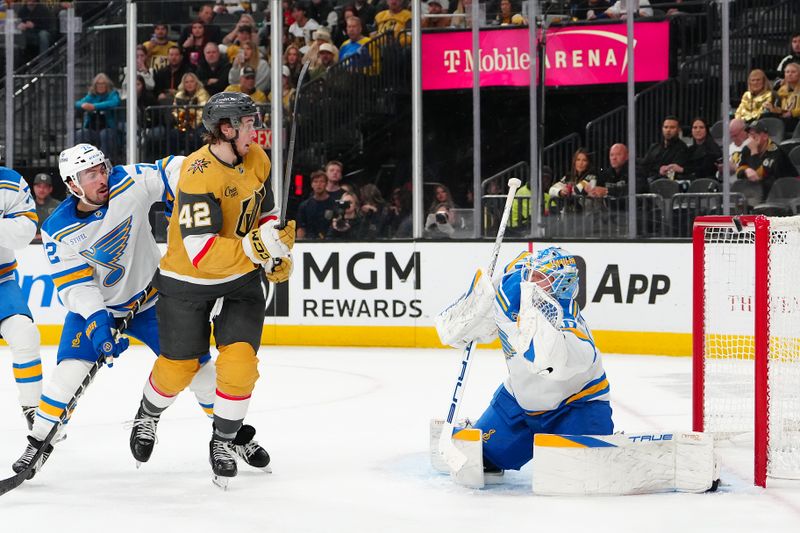 Jan 10, 2026; Las Vegas, Nevada, USA; Vegas Golden Knights right wing Braeden Bowman (42) watches the puck deflect off the crossbar behind St. Louis Blues goaltender Jordan Binnington (50) during the second period at T-Mobile Arena. Mandatory Credit: Stephen R. Sylvanie-Imagn Images