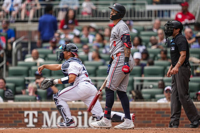 Apr 20, 2025; Cumberland, Georgia, USA; Minnesota Twins shortstop Carlos Correa (4) reacts after being called out on strikes against the Atlanta Braves during the seventh inning at Truist Park. Mandatory Credit: Dale Zanine-Imagn Images