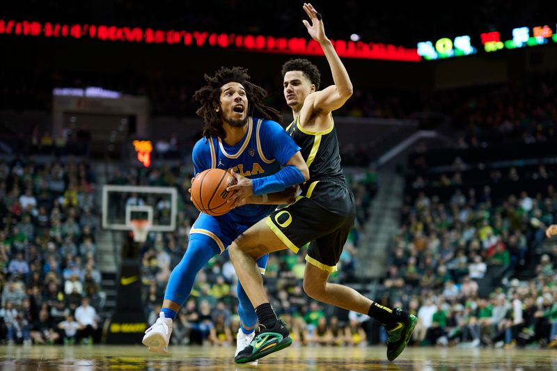 Feb 11, 2023; Eugene, Oregon, USA; UCLA Bruins guard Tyger Campbell (10) drives to the basket during the second half against Oregon Ducks guard Will Richardson (0) at Matthew Knight Arena. Mandatory Credit: Troy Wayrynen-USA TODAY Sports