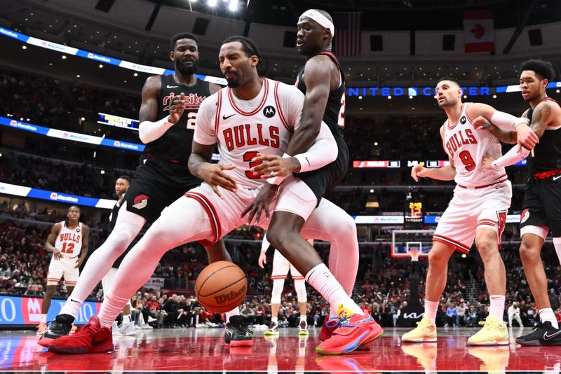 CHICAGO, ILLINOIS - MARCH 18:  Andre Drummond #3 of the Chicago Bulls reacts after being hit in the mouth by Duop Reath #26 of the Portland Trail Blazers in the second half on March 18, 2024 at United Center in Chicago, Illinois. Chicago defeated Portland 110-107.   NOTE TO USER: User expressly acknowledges and agrees that, by downloading and or using this photograph, User is consenting to the terms and conditions of the Getty Images License Agreement.  (Photo by Jamie Sabau/Getty Images)