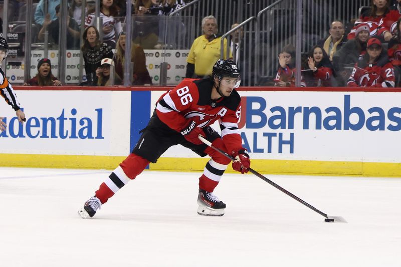 Dec 6, 2024; Newark, New Jersey, USA; New Jersey Devils center Jack Hughes (86) skates with the puck against the Seattle Kraken during the second period at Prudential Center. Mandatory Credit: Ed Mulholland-Imagn Images