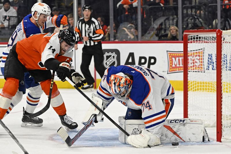 Nov 12, 2025; Philadelphia, Pennsylvania, USA; Edmonton Oilers goaltender Stuart Skinner (74) makes a save against Philadelphia Flyers center Sean Couturier (14) during the first period at Xfinity Mobile Arena. Mandatory Credit: Eric Hartline-Imagn Images