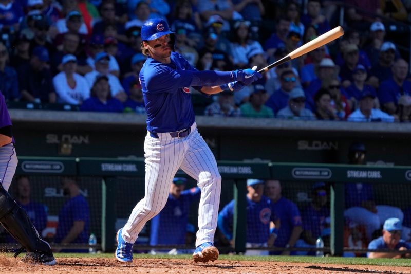 Feb 29, 2024; Mesa, Arizona, USA; Chicago Cubs second baseman Nico Hoerner (2) hits against the Colorado Rockies in the fourth inning at Sloan Park. Mandatory Credit: Rick Scuteri-USA TODAY Sports