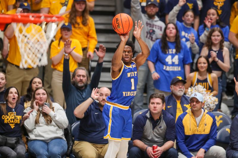 Jan 18, 2025; Morgantown, West Virginia, USA; West Virginia Mountaineers guard Joseph Yesufu (1) shoots a three-point shot during the first half against the Iowa State Cyclones at WVU Coliseum. Mandatory Credit: Ben Queen-Imagn Images