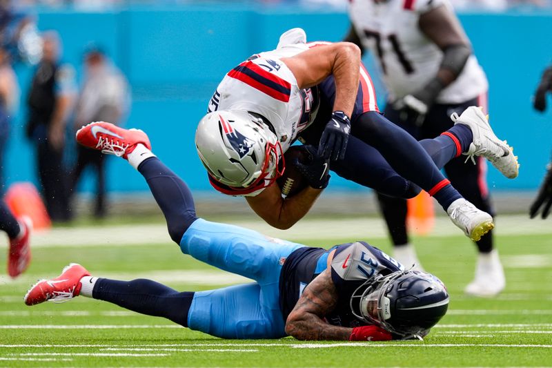 New England Patriots tight end Hunter Henry (85) is tackled by Tennessee Titans safety Amani Hooker (37) during the first half of an NFL football game in Nashville, Tenn., Sunday, Nov. 3, 2024. (AP Photo/George Walker IV)