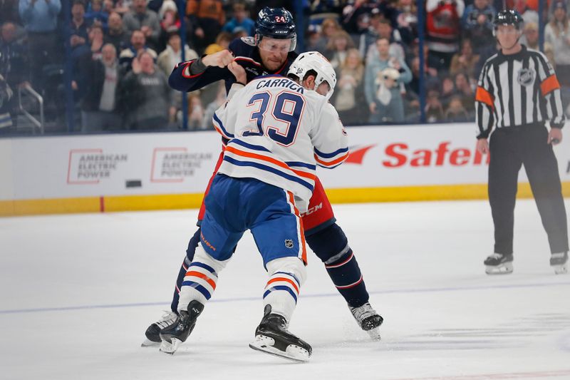 Mar 7, 2024; Columbus, Ohio, USA; Columbus Blue Jackets right wing Mathieu Olivier (24) and Edmonton Oilers center Sam Carrick (39) fight during the first period at Nationwide Arena. Mandatory Credit: Russell LaBounty-USA TODAY Sports