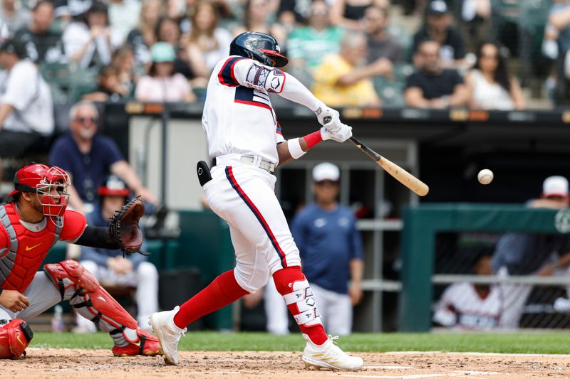 Jul 9, 2023; Chicago, Illinois, USA; Chicago White Sox right fielder Oscar Colas (22) singles against the St. Louis Cardinals during the third inning at Guaranteed Rate Field. Mandatory Credit: Kamil Krzaczynski-USA TODAY Sports