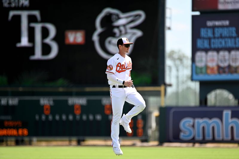 Feb 27, 2023; Sarasota, Florida, USA; Baltimore Orioles left fielder Austin Hayes (21) warms up before the start of the spring training game against the Tampa Bay Rays at Ed Smith Stadium. Mandatory Credit: Jonathan Dyer-USA TODAY Sports