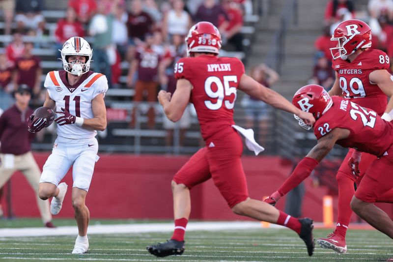 Sep 16, 2023; Piscataway, New Jersey, USA; Virginia Tech Hokies wide receiver Tucker Holloway (11) returns a punt as Rutgers Scarlet Knights punter Flynn Appleby (95) and linebacker Tyreem Powell (22) and tight end Victor Konopka (89) pursue during the second half at SHI Stadium. Mandatory Credit: Vincent Carchietta-USA TODAY Sports