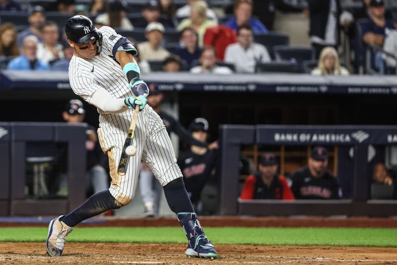 Aug 21, 2024; Bronx, New York, USA;  New York Yankees center fielder Aaron Judge (99) hits a solo home run in the seventh inning against the Cleveland Guardians at Yankee Stadium. Mandatory Credit: Wendell Cruz-USA TODAY Sports