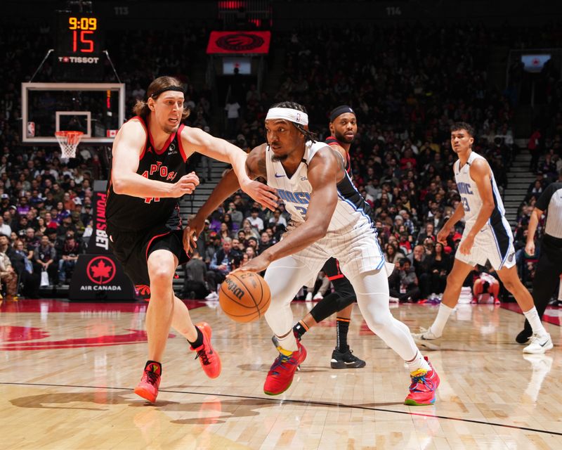 TORONTO, CANADA - JANUARY 3: Wendell Carter Jr. #34 of the Orlando Magic handles the ball during the game against the Toronto Raptors on January 3, 2025 at the Scotiabank Arena in Toronto, Ontario, Canada.  NOTE TO USER: User expressly acknowledges and agrees that, by downloading and or using this Photograph, user is consenting to the terms and conditions of the Getty Images License Agreement.  Mandatory Copyright Notice: Copyright 2025 NBAE(Photo by Mark Blinch/NBAE via Getty Images)