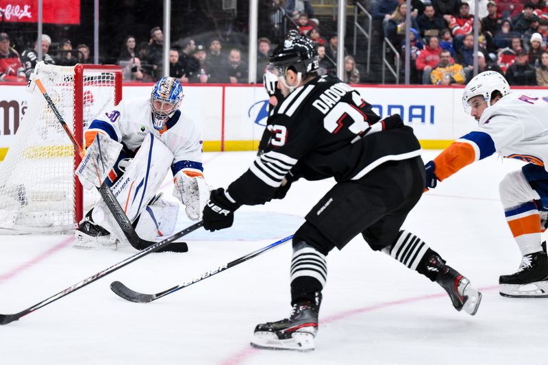 Feb 5, 2026; Newark, New Jersey, USA; New York Islanders goaltender Ilya Sorokin (30) defends against New Jersey Devils left wing Evgenii Dadonov (33) during the second period at Prudential Center. Mandatory Credit: John Jones-Imagn Images
