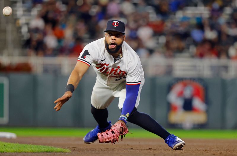 Sep 24, 2024; Minneapolis, Minnesota, USA; Minnesota Twins first baseman Carlos Santana (30) tosses the ball to the pitcher for the out against the Miami Marlins in the sixth inning at Target Field. Mandatory Credit: Bruce Kluckhohn-Imagn Images