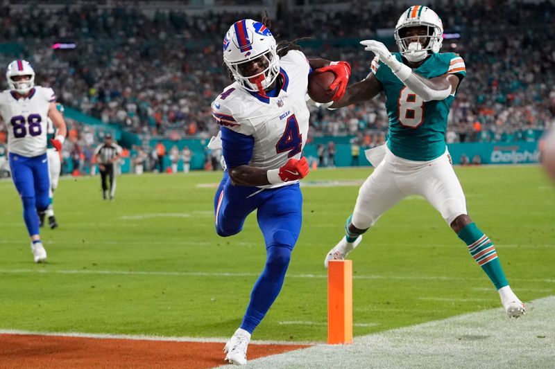 Buffalo Bills running back James Cook (4) scores a touchdown during the first half of an NFL football game against the Miami Dolphins, Thursday, Sept. 12, 2024, in Miami Gardens, Fla. (AP Photo/Lynne Sladky)