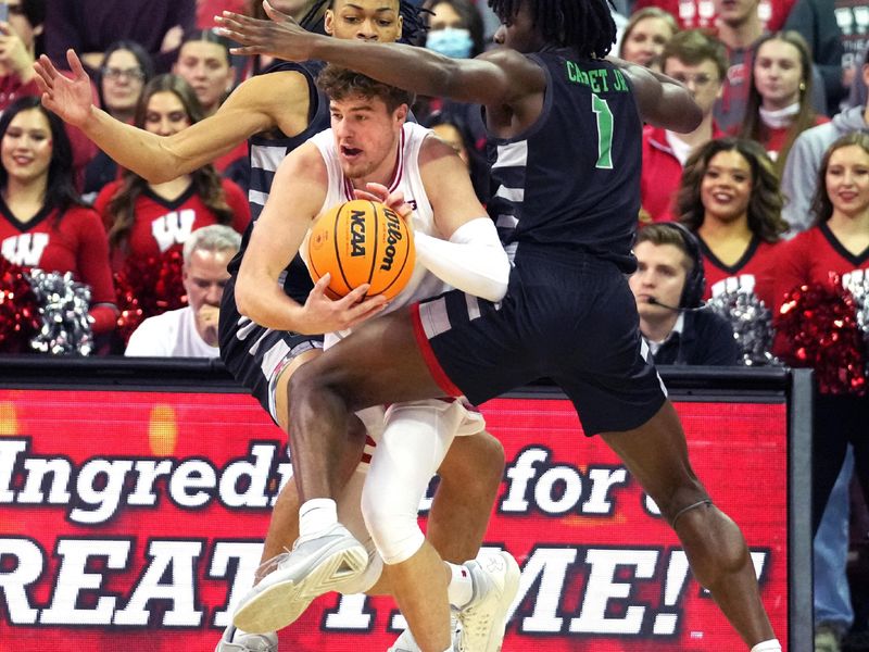 Dec 22, 2023; Madison, Wisconsin, USA; Wisconsin Badgers guard Max Klesmit (11) dribbles the ball against Chicago State Cougars guard Wesley Cardet Jr. (1) and Chicago State Cougars forward Noble Crawford (15) during the first half at the Kohl Center. Mandatory Credit: Kayla Wolf-USA TODAY Sports