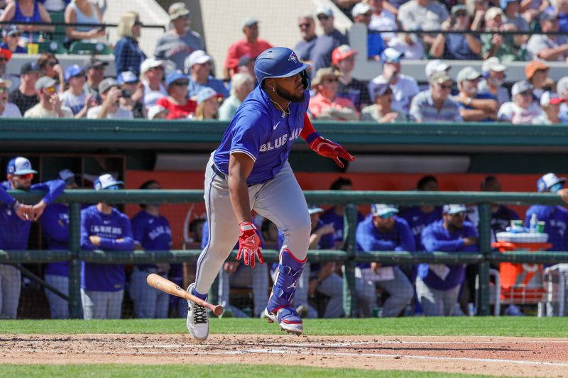 Mar 3, 2025; Lakeland, Florida, USA; Toronto Blue Jays first baseman Vladimir Guerrero Jr. (27) watches a fly ball on the way to first during the fourth inning against the Toronto Blue Jays at Publix Field at Joker Marchant Stadium. Mandatory Credit: Mike Watters-Imagn Images