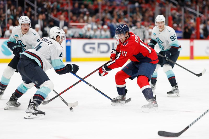 Jan 11, 2024; Washington, District of Columbia, USA; Washington Capitals center Dylan Strome (17) battles for the puck with Seattle Kraken defenseman Justin Schultz (4) in the third period at Capital One Arena. Mandatory Credit: Geoff Burke-USA TODAY Sports