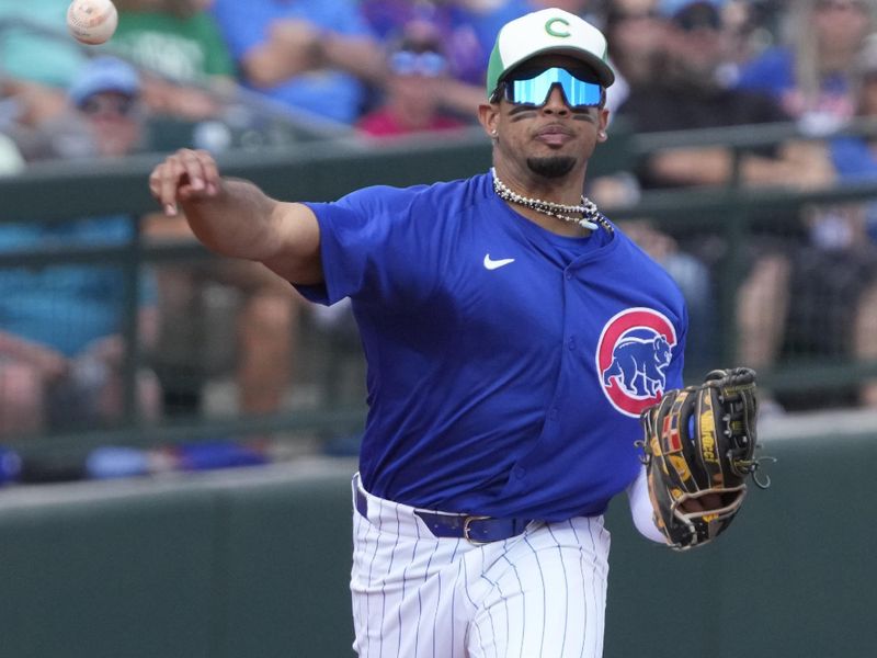 Mar 17, 2024; Mesa, Arizona, USA; Chicago Cubs third baseman Christopher Morel (5) makes the play against the Texas Rangers in the third  inning at Sloan Park. Mandatory Credit: Rick Scuteri-USA TODAY Sports