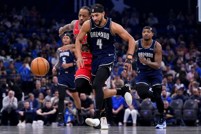 ORLANDO, FLORIDA - APRIL 07: Jalen Suggs #4 of the Orlando Magic dribbles the ball against DeMar DeRozan #11 of the Chicago Bulls during the first quarter at Kia Center on April 07, 2024 in Orlando, Florida. NOTE TO USER: User expressly acknowledges and agrees that, by downloading and or using this photograph, User is consenting to the terms and conditions of the Getty Images License Agreement. (Photo by Rich Storry/Getty Images)