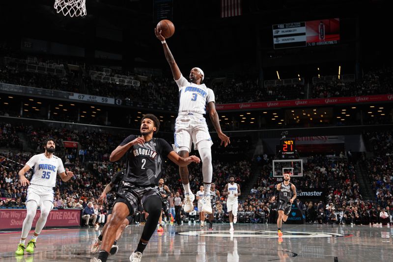 BROOKLYN, NY - DECEMBER 1: Kentavious Caldwell-Pope #3 of the Orlando Magic drives to the basket during the game against the Brooklyn Nets on December 1, 2024 at Barclays Center in Brooklyn, New York. NOTE TO USER: User expressly acknowledges and agrees that, by downloading and or using this Photograph, user is consenting to the terms and conditions of the Getty Images License Agreement. Mandatory Copyright Notice: Copyright 2024 NBAE (Photo by Jesse D. Garrabrant/NBAE via Getty Images)