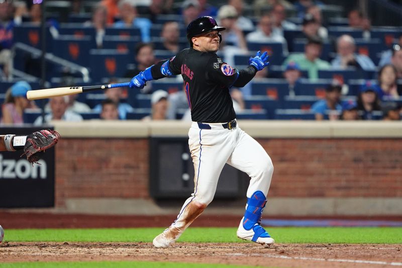 Jul 10, 2024; New York City, New York, USA; New York Mets second baseman Jose Iglesias (11) hits a double against the Washington Nationals during the eighth inning at Citi Field. Mandatory Credit: Gregory Fisher-USA TODAY Sports