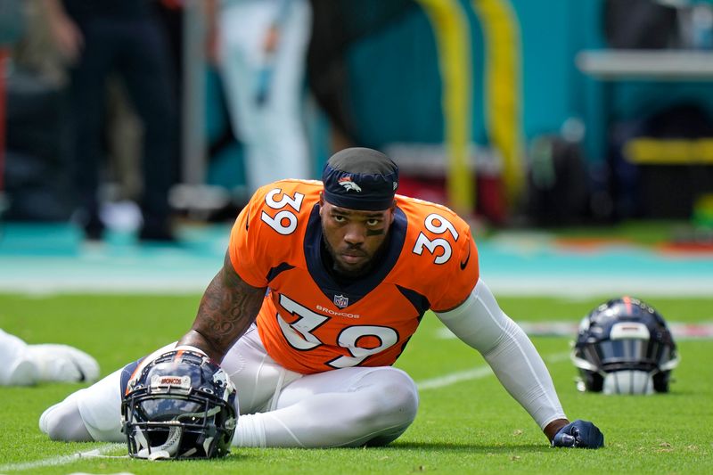 Denver Broncos running back Dwayne Washington stretches out during warm ups before the start of an NFL football game against the Miami Dolphins, Sunday, Sept. 24, 2023, in Miami Gardens, Fla. (AP Photo/Wilfredo Lee)