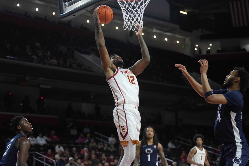 Feb 11, 2025; Los Angeles, California, USA; Southern California Trojans forward Rashaun Agee (12) shoots the ball against Penn State Nittany Lions forward Zach Hicks (24) in the second half at Galen Center. Mandatory Credit: Kirby Lee-Imagn Images