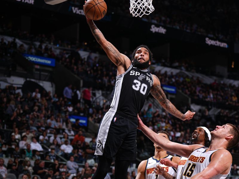 SAN ANTONIO, TX - APRIL 12: Julian Champagnie #30 of the San Antonio Spurs drives to the basket during the game against the Denver Nuggets on April 12, 2024 at the Frost Bank Center in San Antonio, Texas. NOTE TO USER: User expressly acknowledges and agrees that, by downloading and or using this photograph, user is consenting to the terms and conditions of the Getty Images License Agreement. Mandatory Copyright Notice: Copyright 2024 NBAE (Photos by Garrett Ellwood/NBAE via Getty Images)