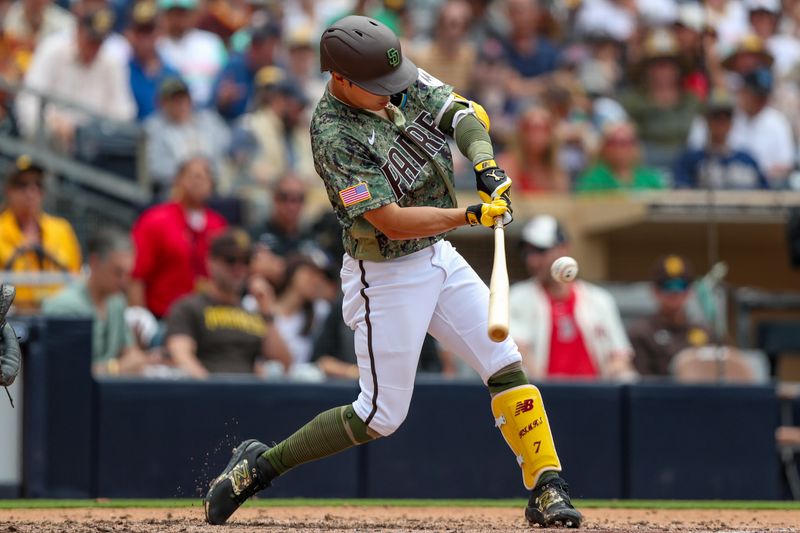 May 21, 2023; San Diego, California, USA; San Diego Padres third baseman Ha-Seong Kim (7) hits a single in the sixth inning against the Boston Red Sox at Petco Park. Mandatory Credit: David Frerker-USA TODAY Sports