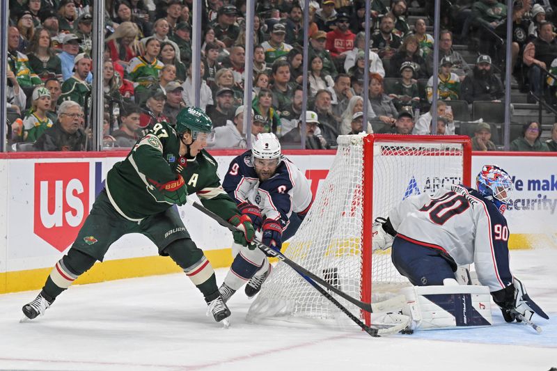 Oct 11, 2025; Saint Paul, Minnesota, USA; Columbus Blue Jackets goalie Elvis Merzlikins (90) makes a save on Minnesota Wild forward Kirill Kaprizov (97) as defensemen Ivan Provorov (9) defends during the second period at Grand Casino Arena. Mandatory Credit: Nick Wosika-Imagn Images