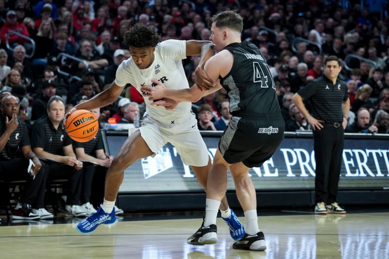 Dec 14, 2024; Cincinnati, Ohio, USA; Xavier Musketeers guard Dailyn Swain (3) dribbles the ball against Cincinnati Bearcats guard Simas Lukosius (41) in the first half at Fifth Third Arena. Mandatory Credit: Aaron Doster-Imagn Images