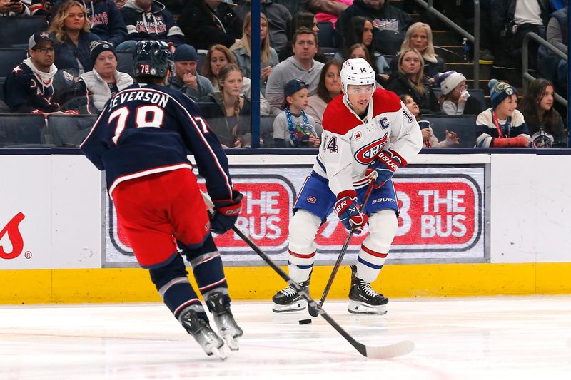 Nov 27, 2024; Columbus, Ohio, USA; Montreal Canadiens center Nick Suzuki (14) controls the puck as Columbus Blue Jackets defenseman Damon Severson (78) defends during the third period at Nationwide Arena. Mandatory Credit: Russell LaBounty-Imagn Images