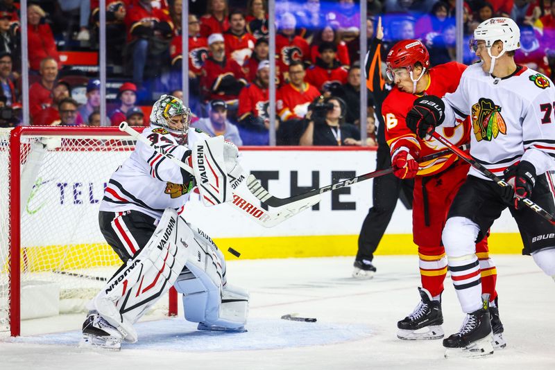 Oct 15, 2024; Calgary, Alberta, CAN; Calgary Flames left wing Andrei Kuzmenko (96) scores a goal against Chicago Blackhawks goaltender Petr Mrazek (34) during the second period at Scotiabank Saddledome. Mandatory Credit: Sergei Belski-Imagn Images