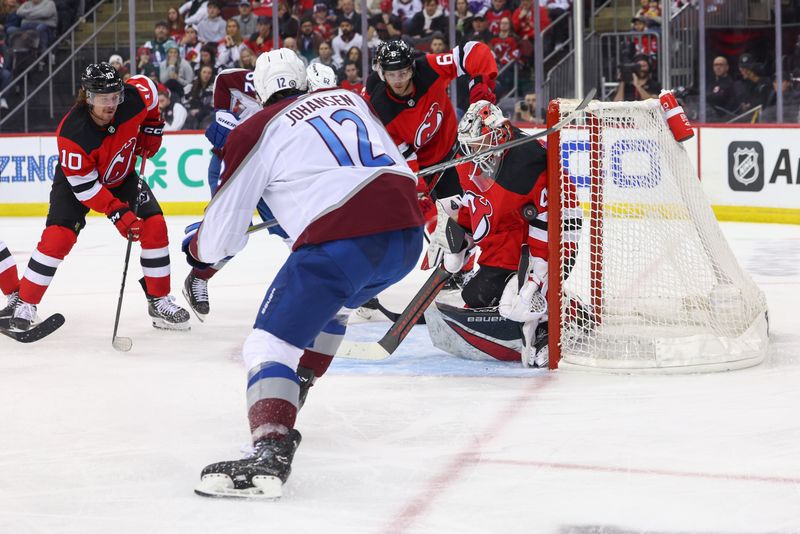 Feb 6, 2024; Newark, New Jersey, USA; New Jersey Devils goaltender Vitek Vanecek (41) makes a save on Colorado Avalanche center Ryan Johansen (12) during the first period at Prudential Center. Mandatory Credit: Ed Mulholland-USA TODAY Sports