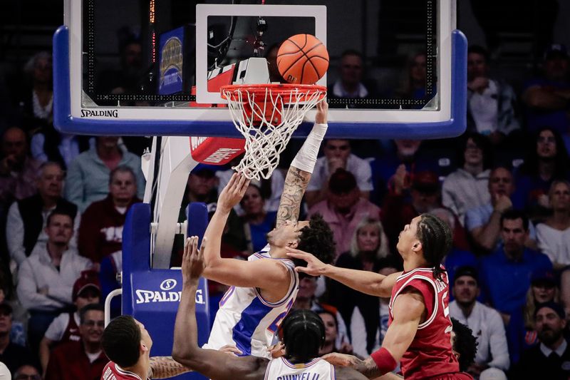 Feb 28, 2026; Gainesville, Florida, USA; Florida Gators guard Isaiah Brown (20) drives to the basket against Arkansas Razorbacks guard Darius Acuff Jr. (5) during the first half at Exactech Arena at the Stephen C. O'Connell Center. Mandatory Credit: Travis Register-Imagn Images