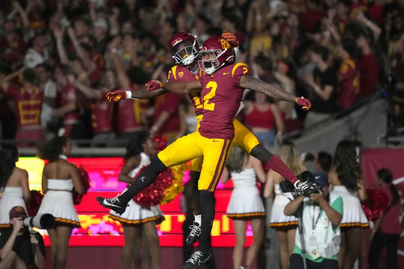 Sep 9, 2023; Los Angeles, California, USA; Southern California Trojans wide receiver Brenden Rice (2) celebrates with wide receiver Tahj Washington (16) after scoring on a 75-yard touchdown reception against the Stanford Cardinal in the first half at United Airlines Field at Los Angeles Memorial Coliseum. Mandatory Credit: Kirby Lee-USA TODAY Sports