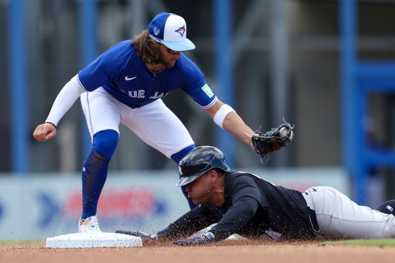 Mar 12, 2024; Dunedin, Florida, USA;  New York Yankees first baseman Jose Rojas (83) slides into second after hitting a double against the Toronto Blue Jays in the fourth inning at TD Ballpark. Mandatory Credit: Nathan Ray Seebeck-USA TODAY Sports