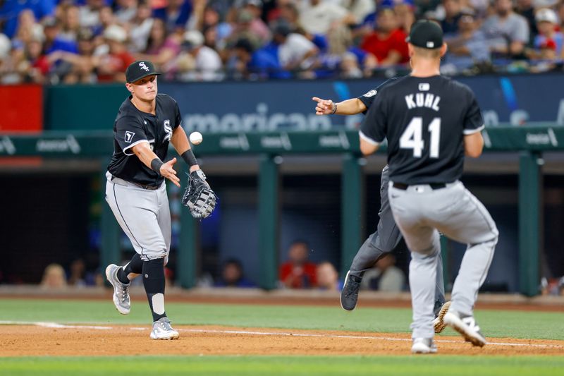 Jul 23, 2024; Arlington, Texas, USA; Chicago White Sox first base Andrew Vaughn (25) tosses to pitcher Chad Kuhl (41) during the sixth inning against the Texas Rangers at Globe Life Field. Mandatory Credit: Andrew Dieb-USA TODAY Sports