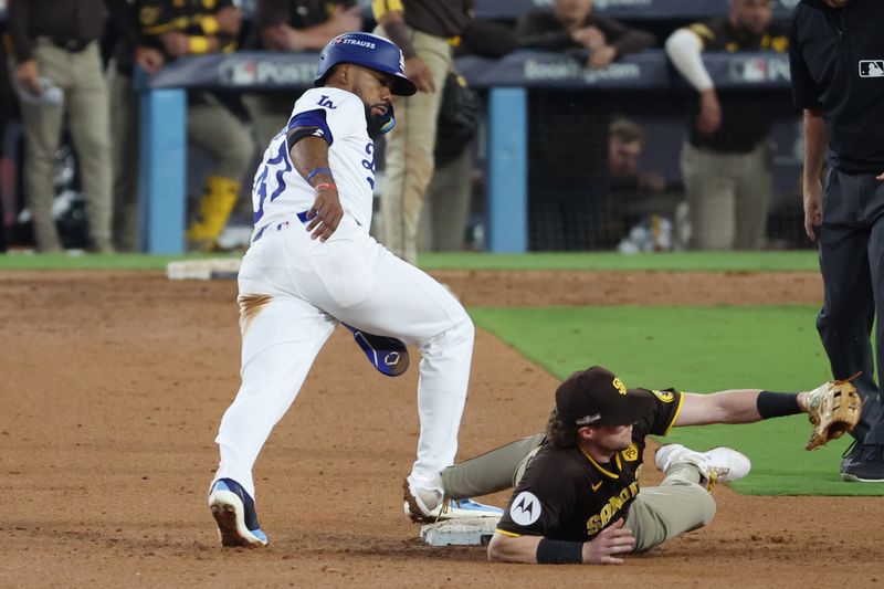 Oct 6, 2024; Los Angeles, California, USA; Los Angeles Dodgers outfielder Teoscar Hernandez (37) steals second base against San Diego Padres first baseman Jake Cronenworth (9) in the seventh inning during game two of the NLDS for the 2024 MLB Playoffs at Dodger Stadium. Mandatory Credit: Kiyoshi Mio-Imagn Images